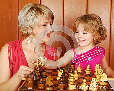 Mother and daughter play chess Stock Photo