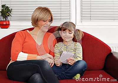Mother and daughter play with tablet pc Stock Photo