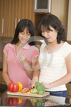 Mother And Daughter Preparing Meal Stock Photo