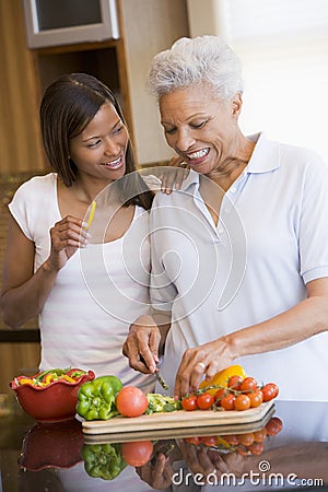 Mother And Daughter Preparing A Meal Stock Photo