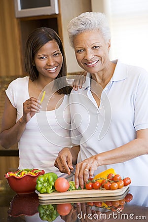 Mother And Daughter Preparing A Meal Stock Photo