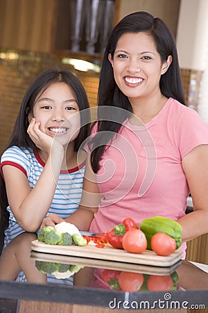 Mother And Daughter Preparing A Meal Stock Photo