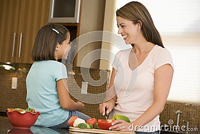 Mother And Daughter Preparing A Meal Stock Photo