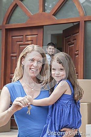 Mother and daughter smiling and holding the keys to their new house Stock Photo
