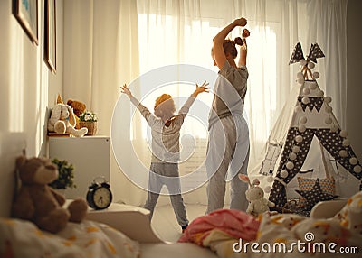 Mother and daughter stretch themselves after waking up in the Stock Photo