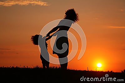 Mother and daughter on sunset watching on sky Stock Photo