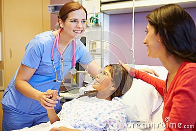 Mother And Daughter Talking To Female Nurse In Hospital Room Stock Photo