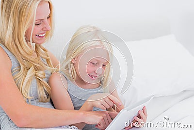 Mother and daughter touching a tablet Stock Photo