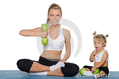 Mother with daughter train weights of apples Stock Photo