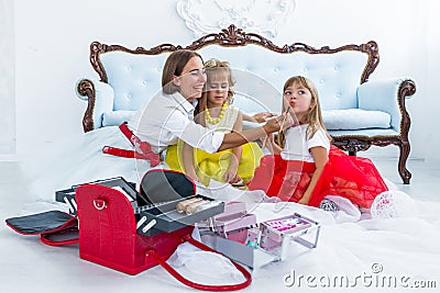 Mother and daughters doing makeup Stock Photo