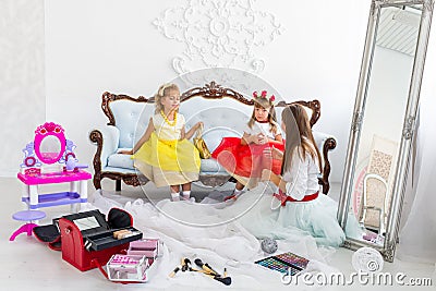 Mother and daughters doing makeup Stock Photo