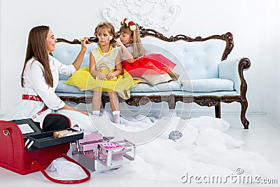 Mother and daughters doing makeup Stock Photo