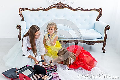 Mother and daughters doing makeup Stock Photo