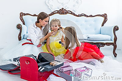 Mother and daughters doing makeup Stock Photo