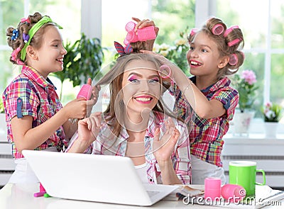 Mother and daughters making hairstyles Stock Photo