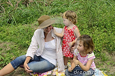 Mother and daughters playing outdoors Stock Photo