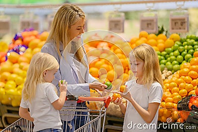 Mother and daughters shopping for food in groceries store Stock Photo