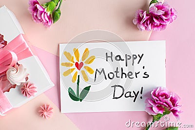 Mother day greeting card on pink background. Text Happy Mothers day. Breakfast, carnation gift and a postcard made by Stock Photo