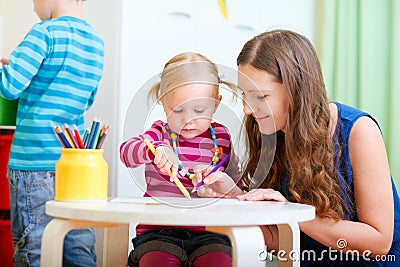 Mother drawing together with her daughter Stock Photo