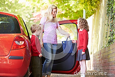 Mother Driving To School With Children Stock Photo