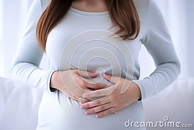 Mother expecting woman holding hand on belly touching pregnancy baby child birth health care life body care healthy pain Stock Photo