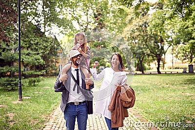 Mother and father playing with daughter Stock Photo