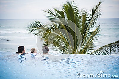 Mother, Father, & Toddler Son in Pool in Mexico Stock Photo