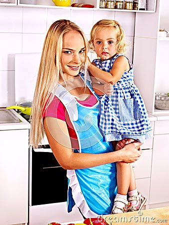 Mother feed child at kitchen. Stock Photo