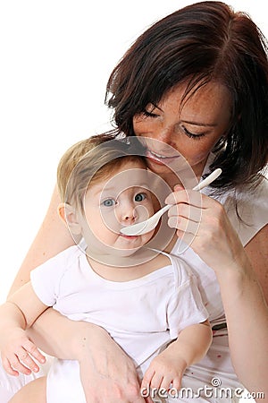 Mother feeding hungry baby Stock Photo