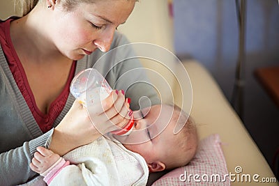 Mother feeding infant baby Stock Photo