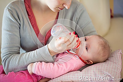 Mother feeding infant baby Stock Photo