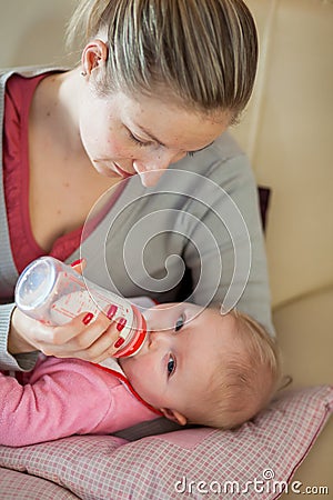 Mother feeding infant baby Stock Photo