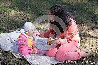 Mother feeding infant baby Stock Photo
