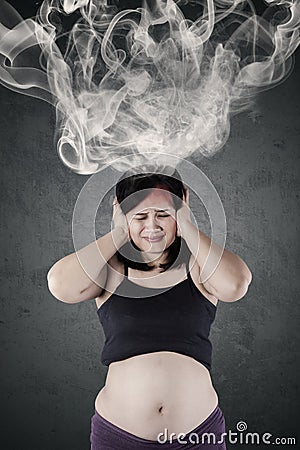Mother feeling confused with smoke on head Stock Photo
