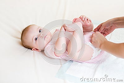 Mother getting baby dressed Stock Photo