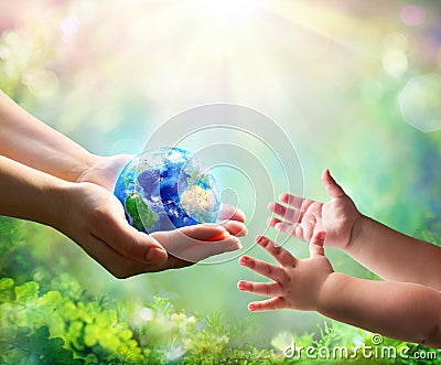 Mother Give Blue Earth In Daughter Hands Stock Photo