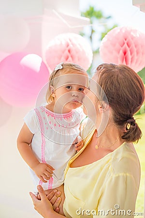 Mother Giver Sweet Kiss to Her Little Daughter Stock Photo