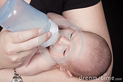 Mother giving baby bottle Stock Photo