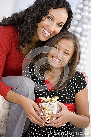 Mother Giving Daughter Her Christmas Present Stock Photo