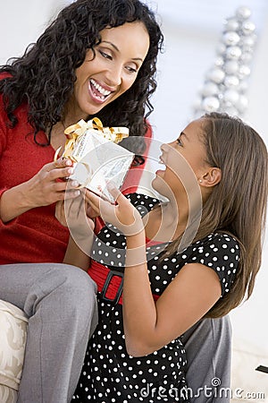 Mother Giving Daughter Her Christmas Present Stock Photo