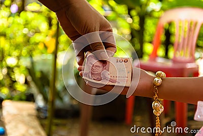 Mother giving her child money Stock Photo