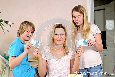 Mother giving her children pocket money Stock Photo