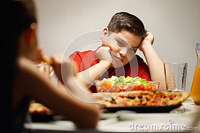 Mother Giving Salad Instead Of Pizza To Overweight Son Stock Photo