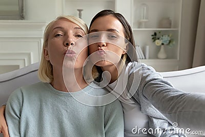 Mother and grownup daughter posing making selfie webcam view Stock Photo