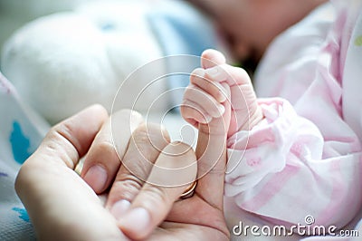 Mother hand holding the baby. Photo taken in the neonatal Gynecological Stock Photo