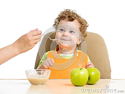 Mother hand spoon feeding baby Stock Photo