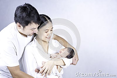 The mother held the baby in her hand. One month old baby on the hands of mother and father. Parents and newborn children Stock Photo
