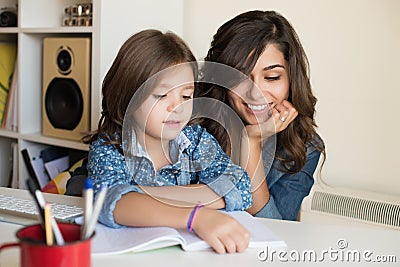 Mother helping child with homework Stock Photo