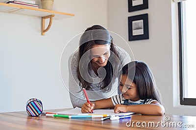 Mother helping daughter draw Stock Photo