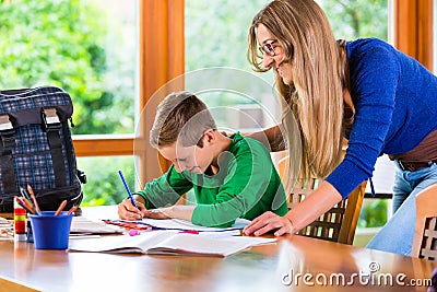 Mother helping with school homework assignment Stock Photo